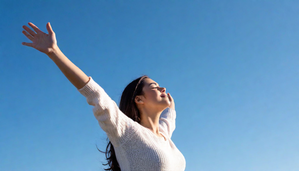 A content woman with arms raised to the sky, taking a deep breath, symbolizing relaxation, stress relief, and mental resilience in liver cancer care.